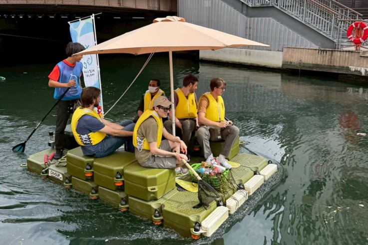 道頓堀川でサップボートに乗った外国人観光客4名がツアーに参加している様子