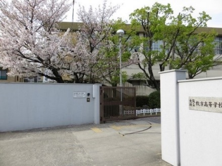 校門と校舎の写真（桜が咲いている）